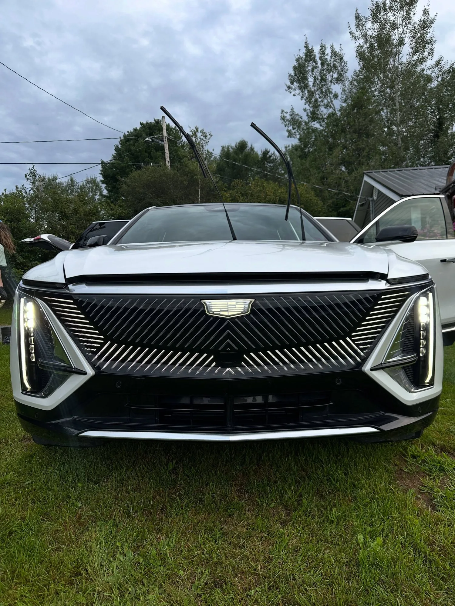 White Cadillac Lyriq after an exterior detail, parked on the grass