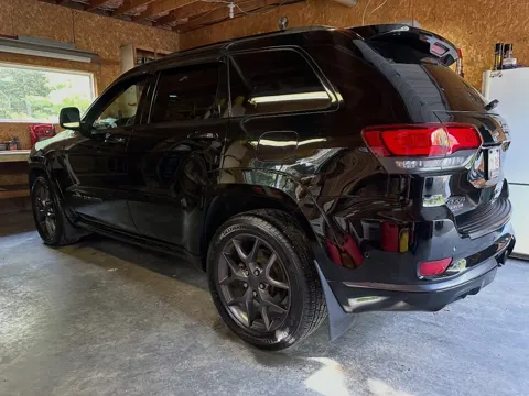 Black Jeep Grand Cherokee freshly detailed in a garage