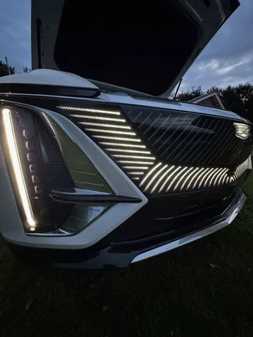 Close-up of a Cadillac Lyriq headlight and grille after the wash